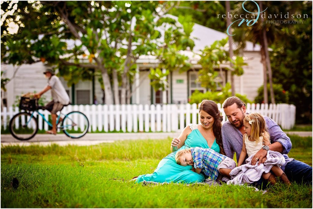 family in grass with old cayman house island bump session