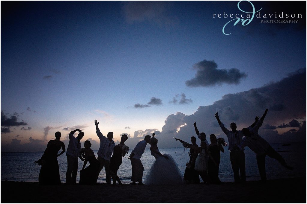silhouette of bridal party on beach