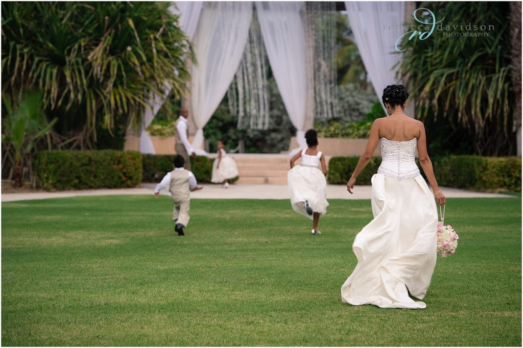 children running on lawn for wedding