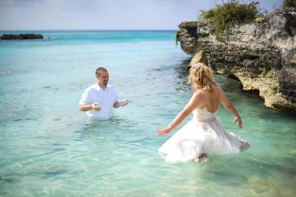 couple in ocean with wedding clothes