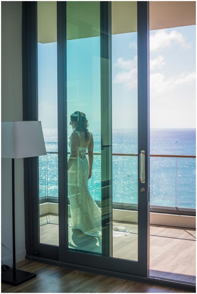 bride walks along balcony overlooking seven mile beach