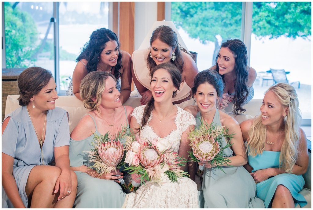 girls in blue teal bridal outfits with proteas flowers