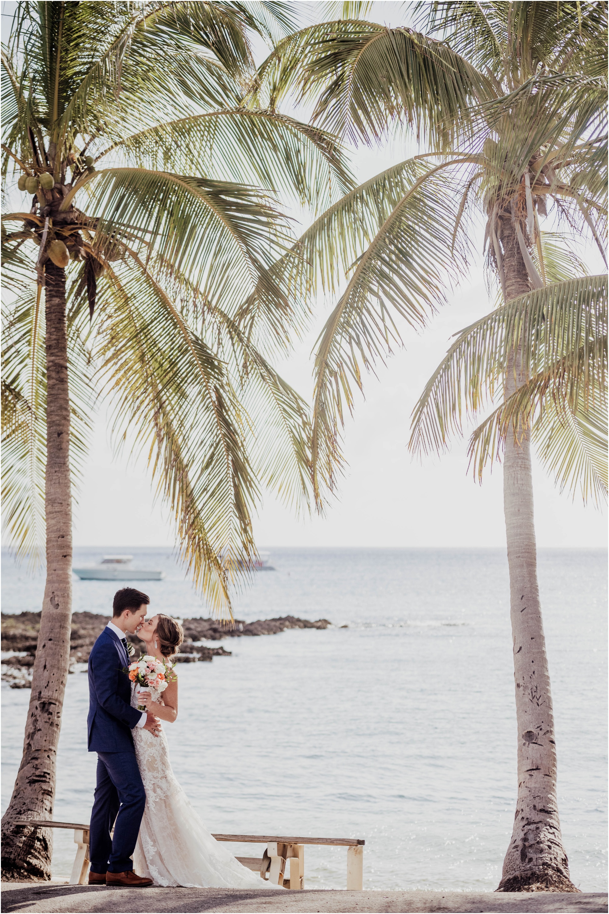 bride and groom in cayman islands, groom in navy blue suit, bride in essence of austria gown