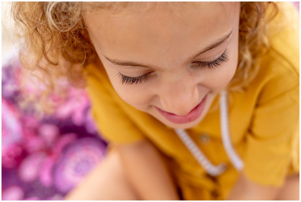 eyelashes on little girl with yellow dress