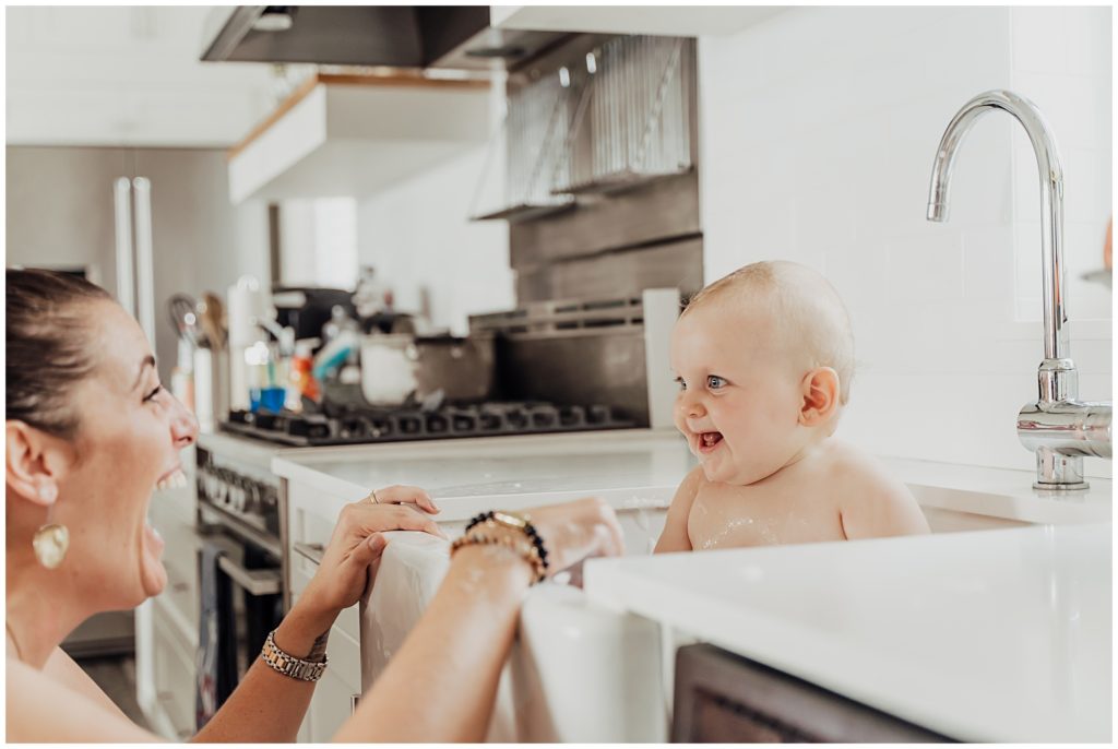 bath time baby in kitchen sink