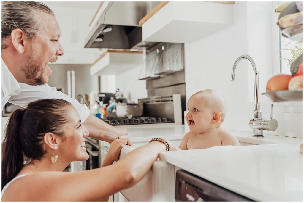 bath time baby in kitchen sink