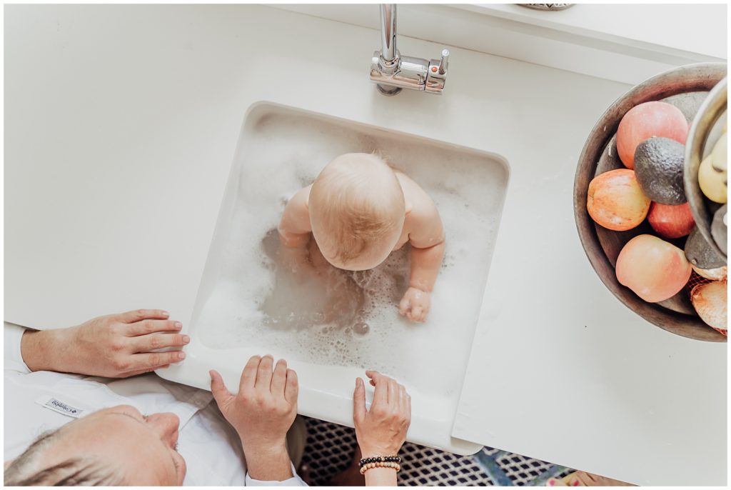 bath time baby in kitchen sink