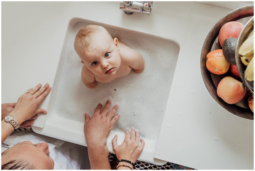 bath time baby in kitchen sink