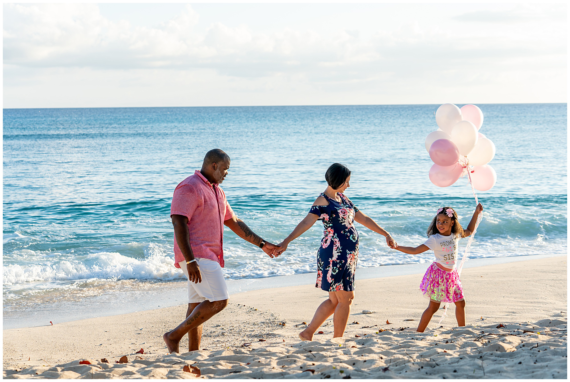 maternity session family in pink on beach